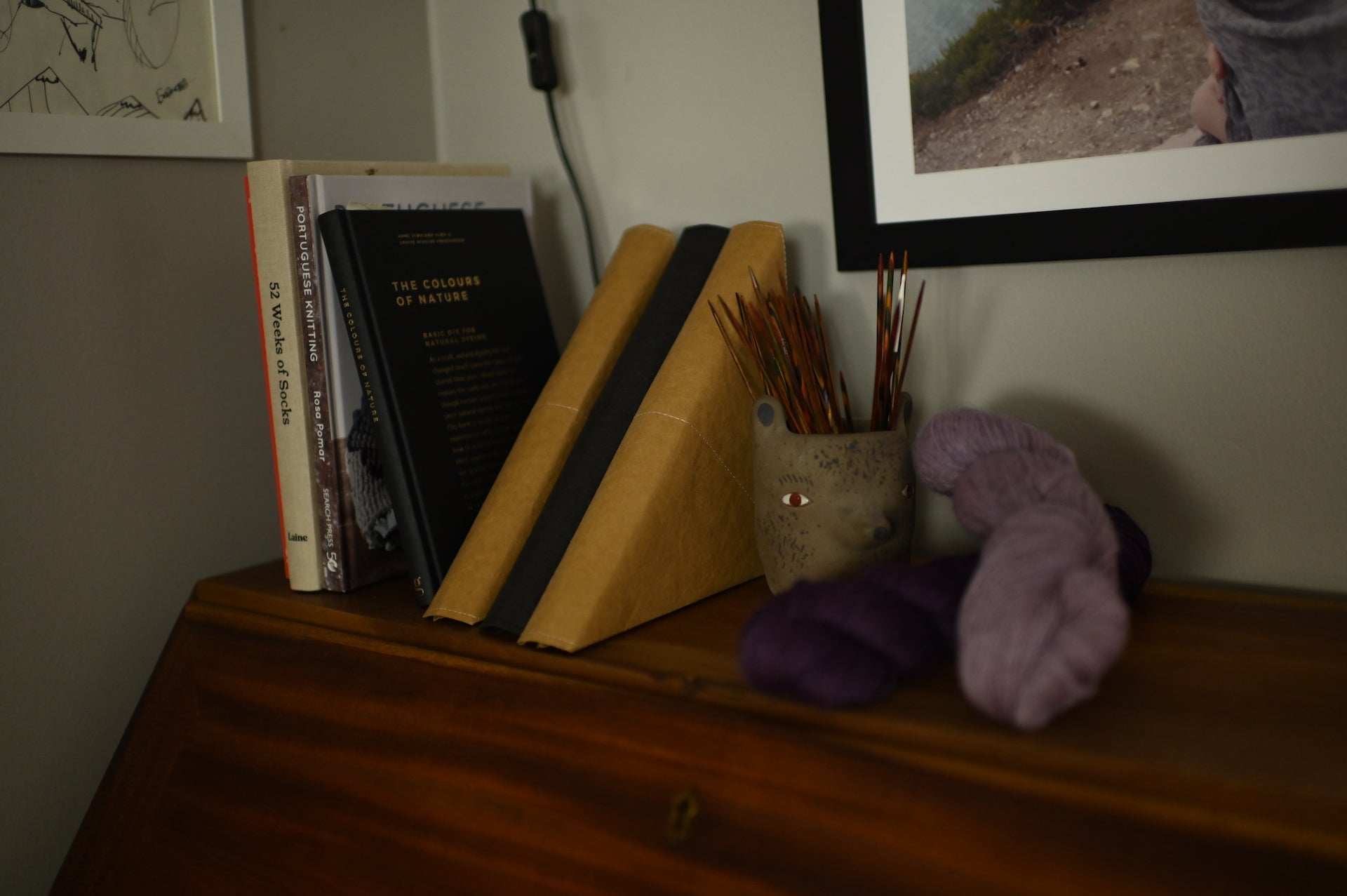 Rundstricknadeltasche ANWEN steht auf dem Sekretär neben Strick Bücher, Nadelspiele und Wolle